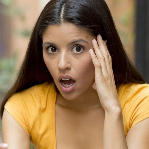 woman stunned looking at her phone