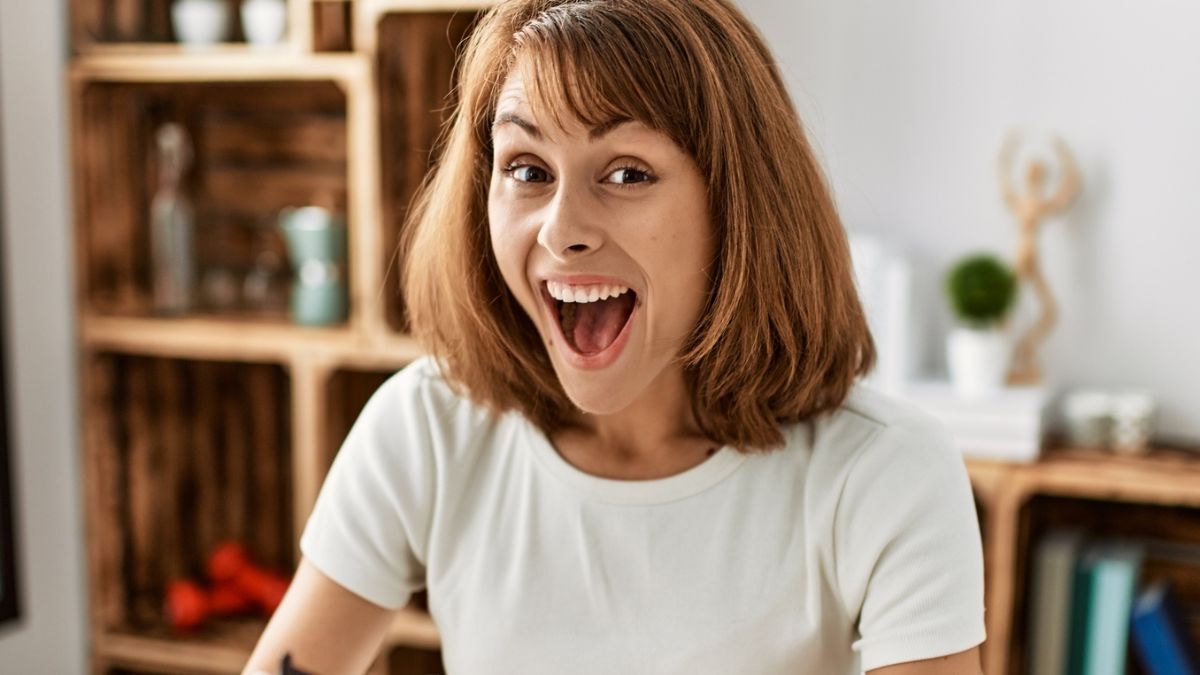 woman surprised looking at wallet