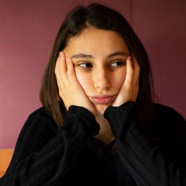 woman thinking on her bed