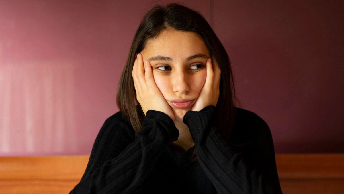 woman thinking on her bed