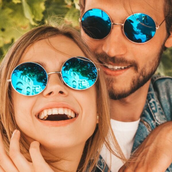 couple smiling with sun glasses