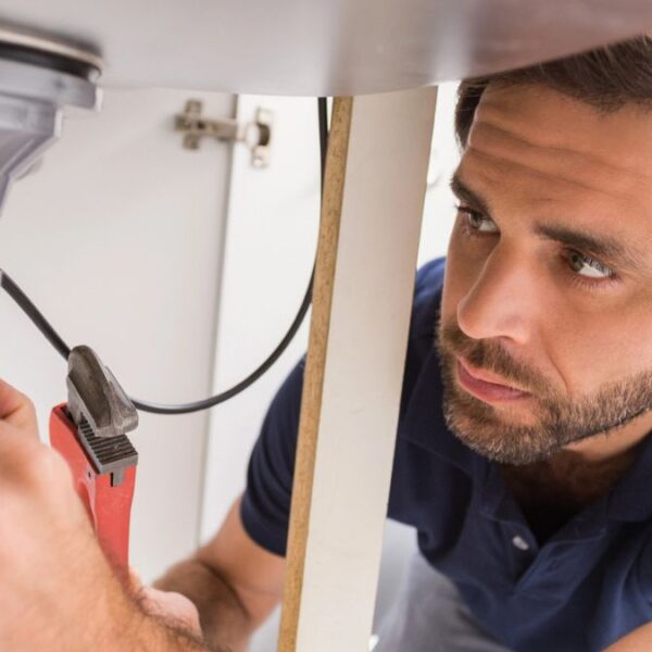 man fixing sink drain