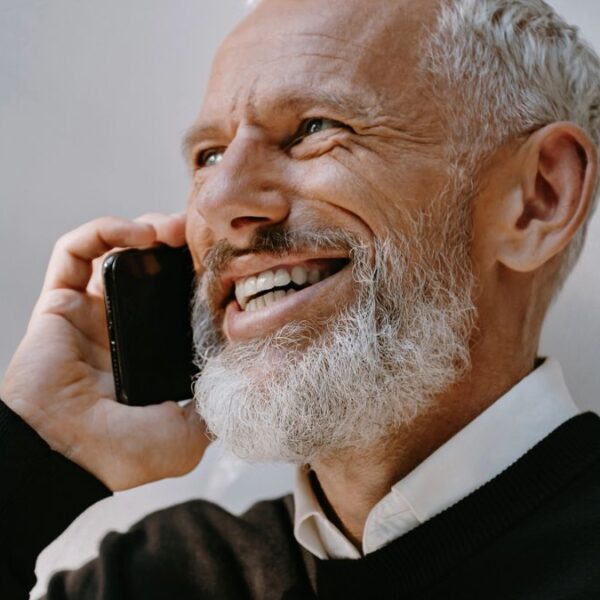 man in long sleeve on a phone call