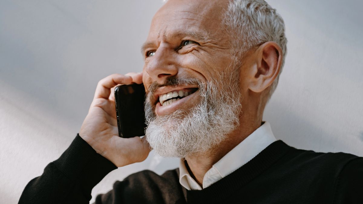 man in long sleeve on a phone call