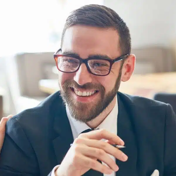 man in suit and glasses talking