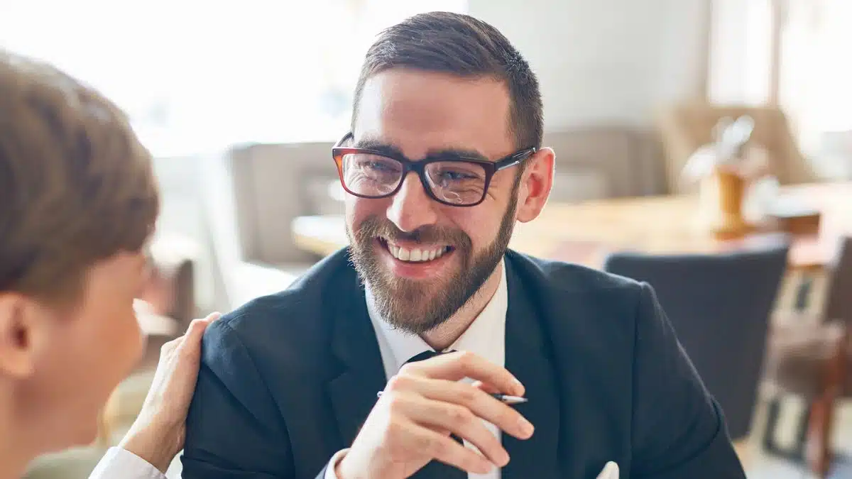 man in suit and glasses talking