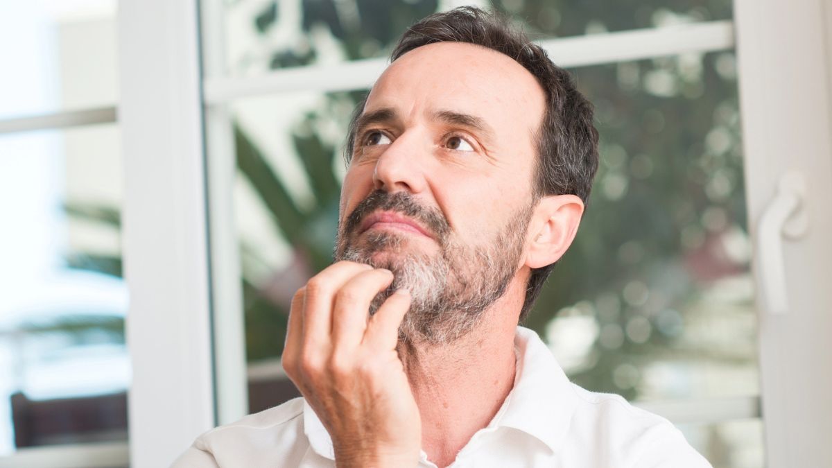 man mature thinking at home
