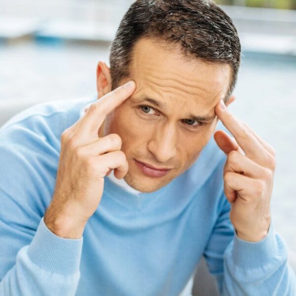 man pointing to his brain