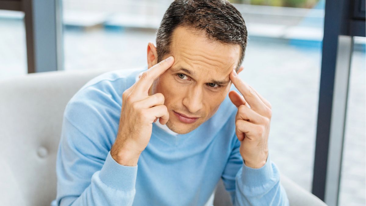 man pointing to his brain