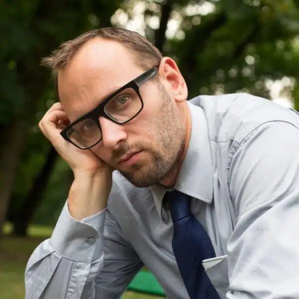 man sad sitting on a bench