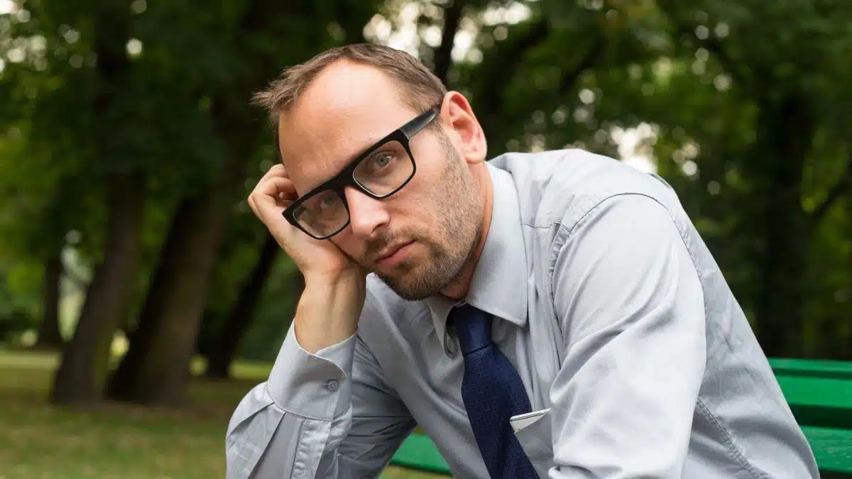 man sad sitting on a bench