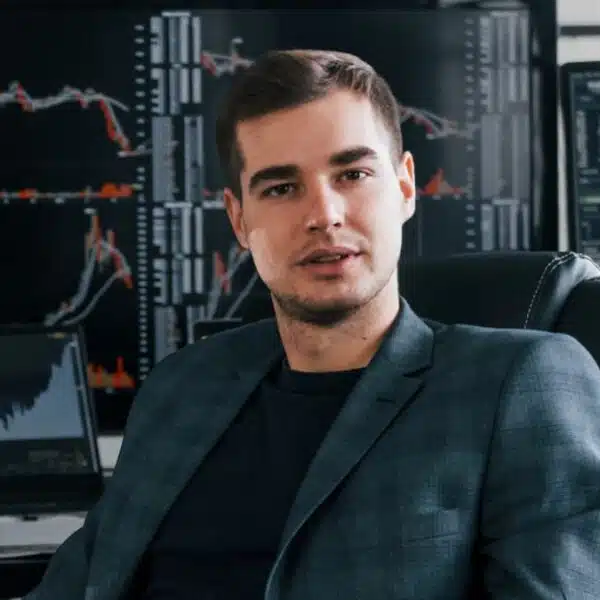 man sitting at stock broker desk