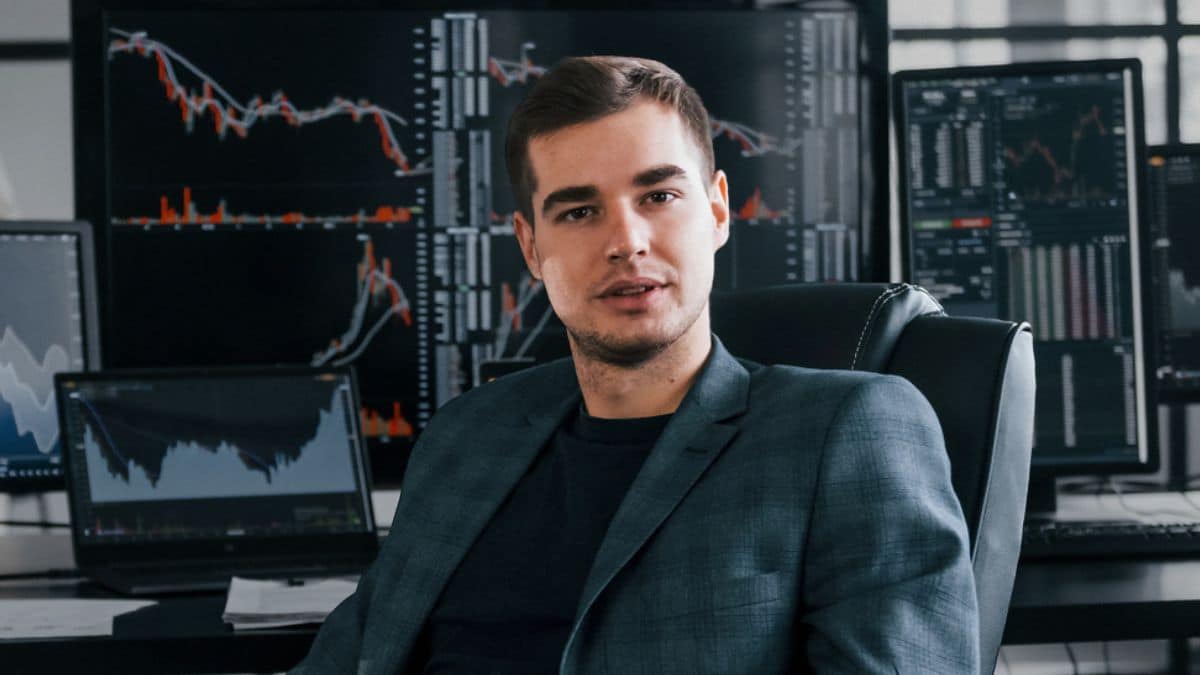 man sitting at stock broker desk