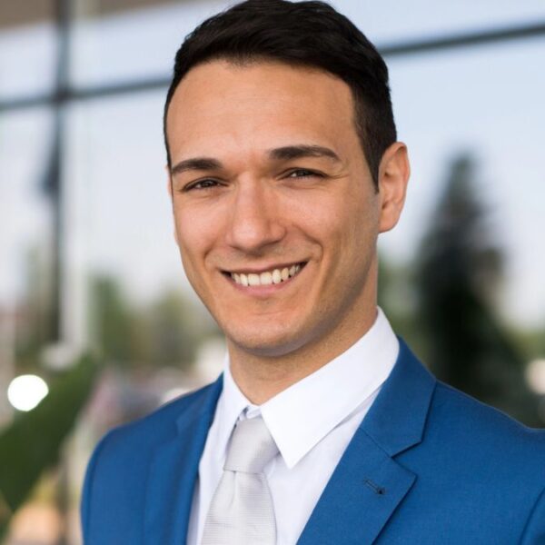 man wearing a suit smiling outside