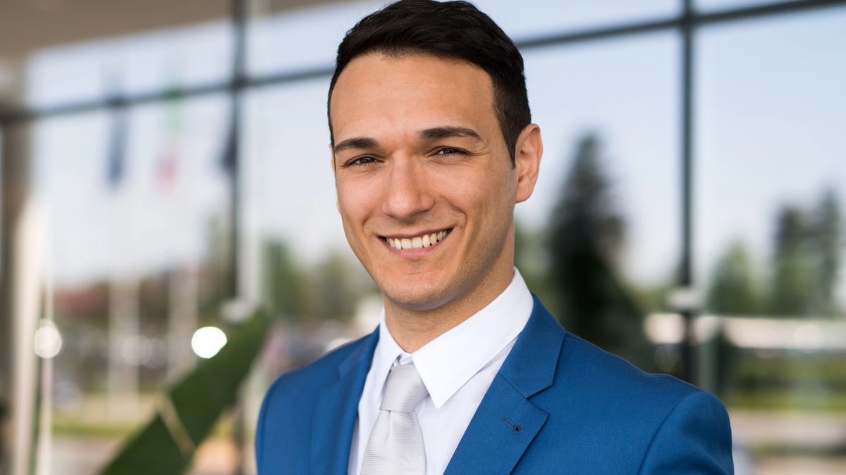 man wearing a suit smiling outside