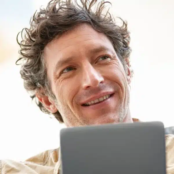 man with tablet sitting alone