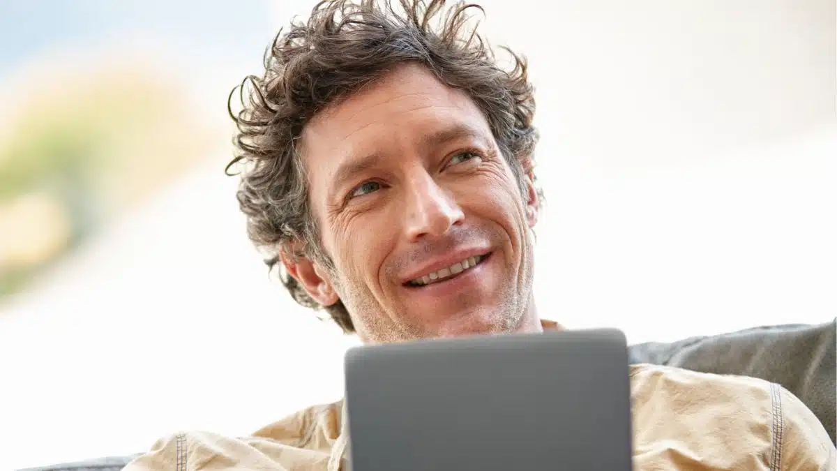 man with tablet sitting alone