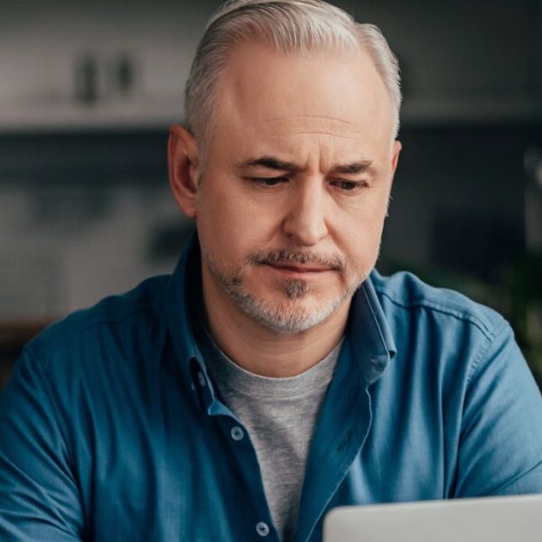 mature man on his laptop at home
