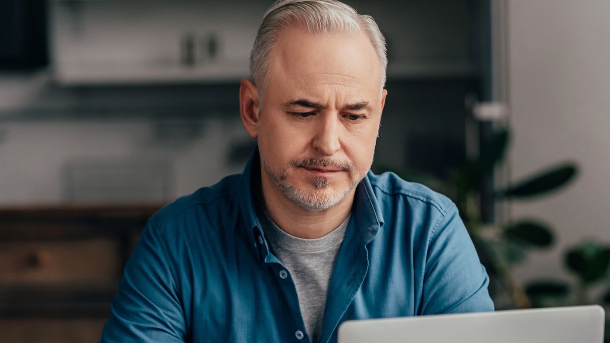 mature man on his laptop at home