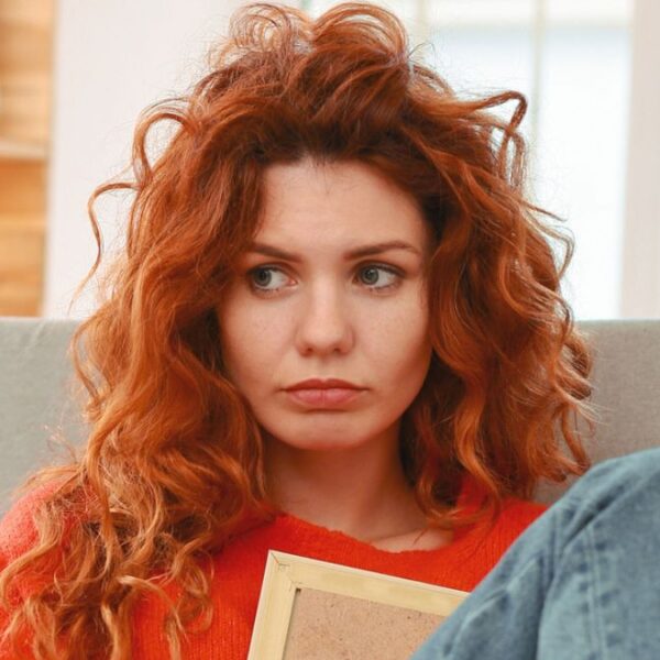 redhead woman worried in her home