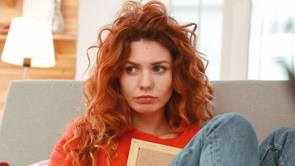 redhead woman worried in her home