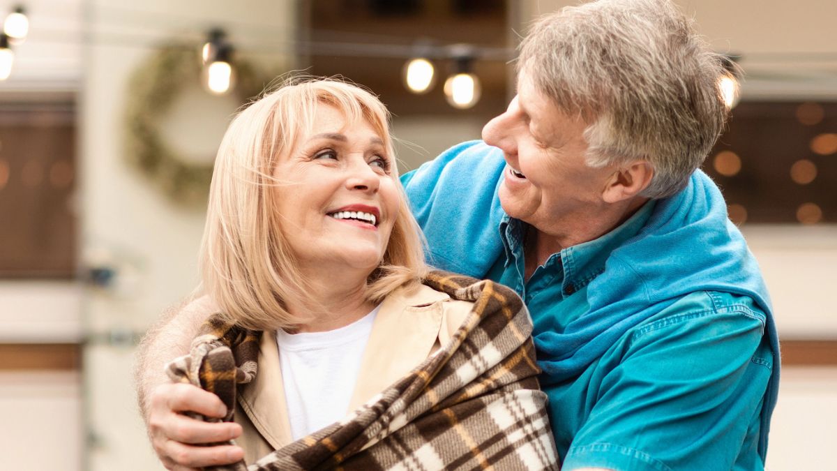 senior couple in front of a rv