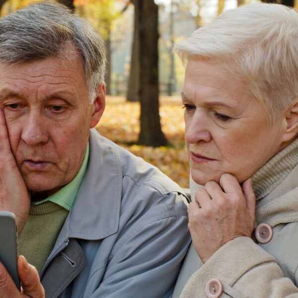 senior couple looking at their phone