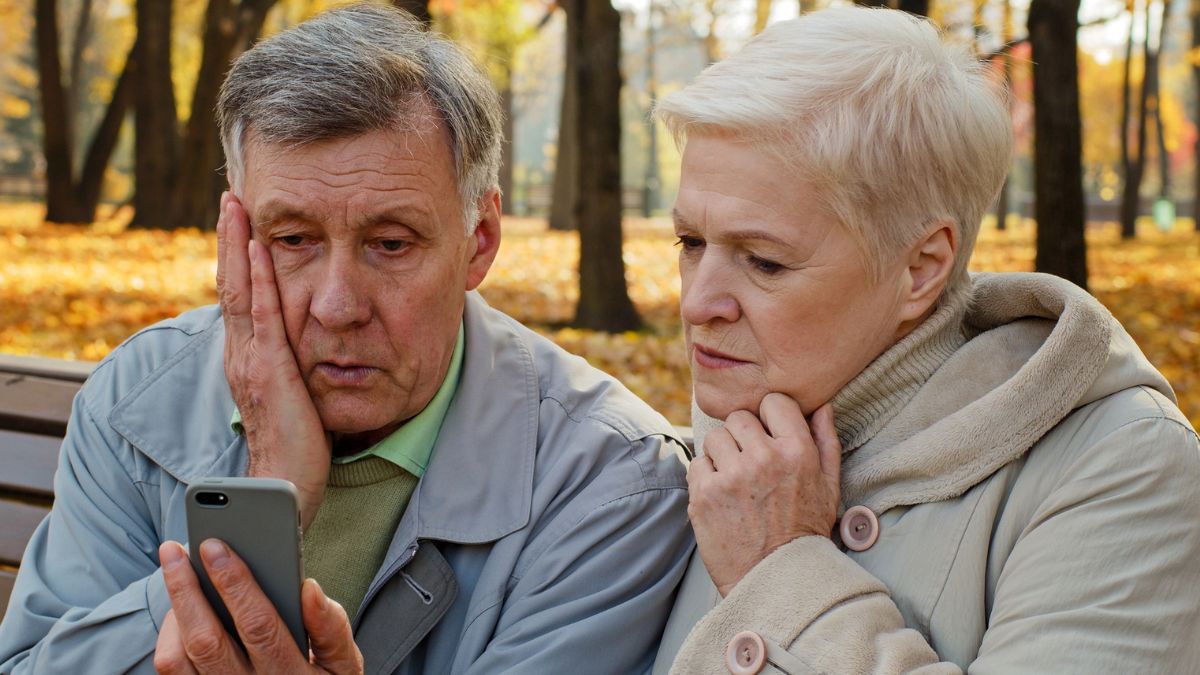 senior couple looking at their phone