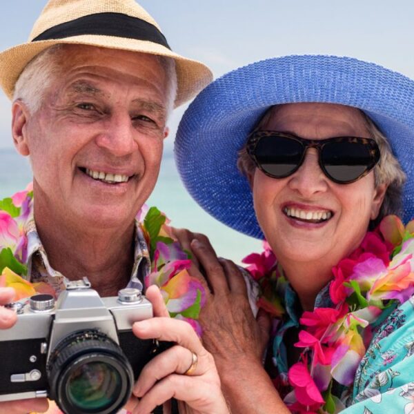 senior couple smiling sun glasses vacations