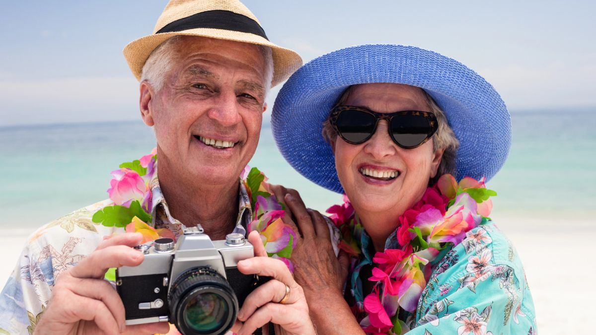 senior couple smiling sun glasses vacations