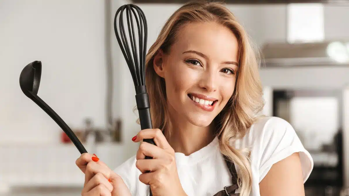 woman cooking with spoons