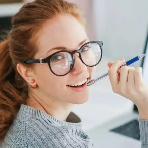 woman glasses sitting at laptop