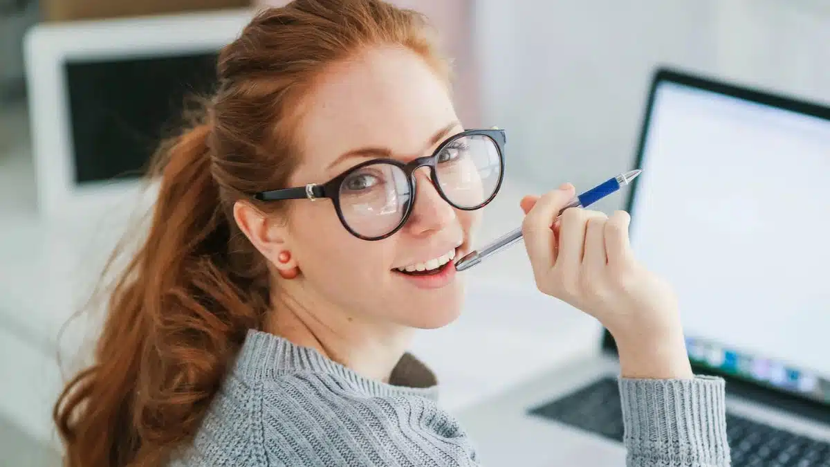 woman glasses sitting at laptop