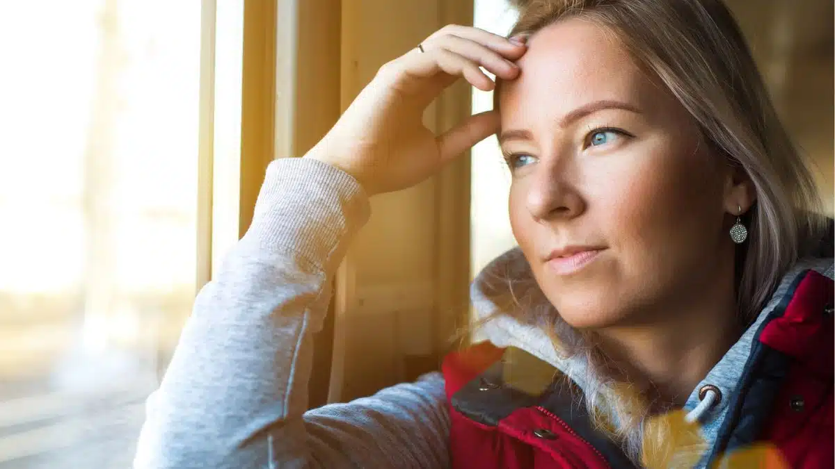 woman looking out the train