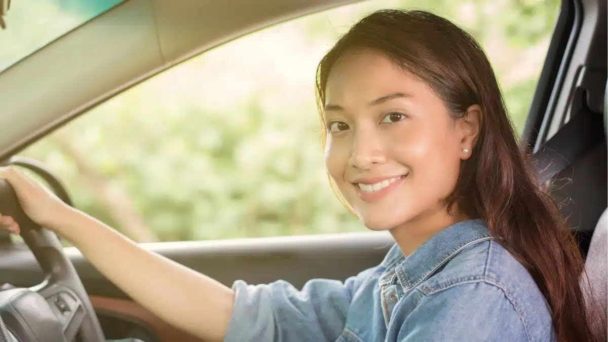 woman smiling in her car