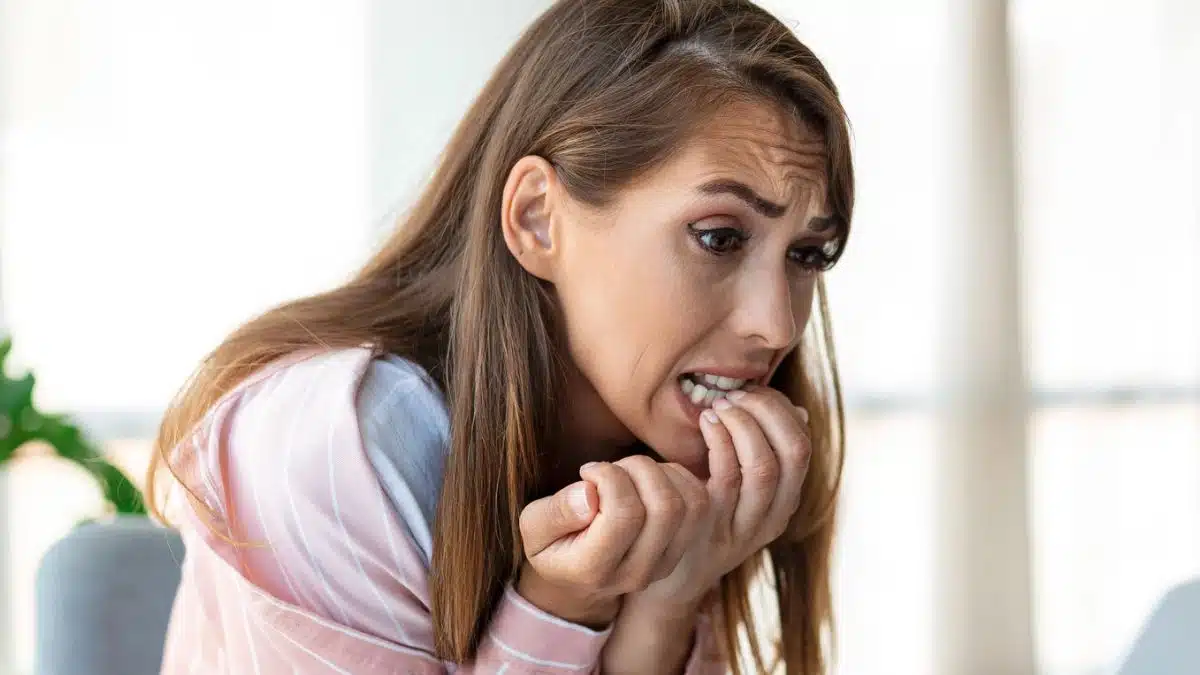 woman stressed biting nails
