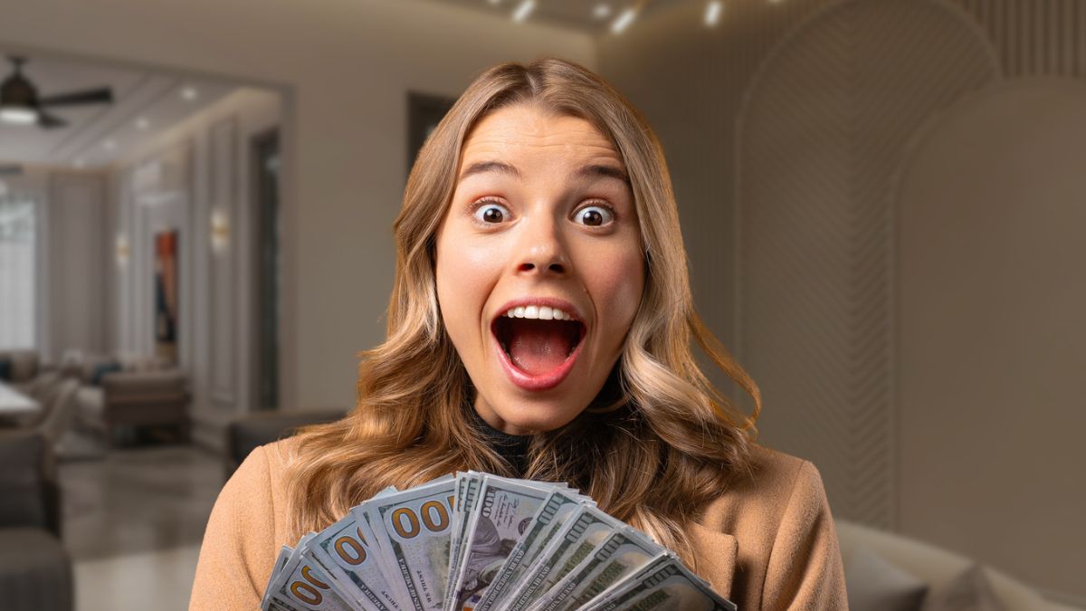 woman surprised holding cash