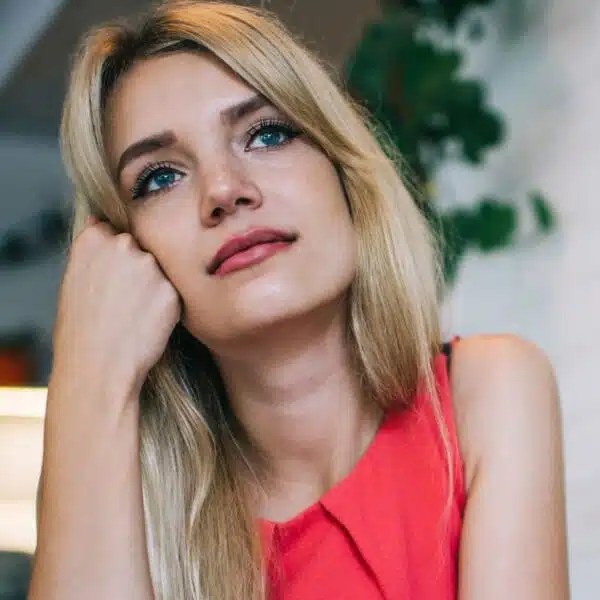 woman thinking alone red dress