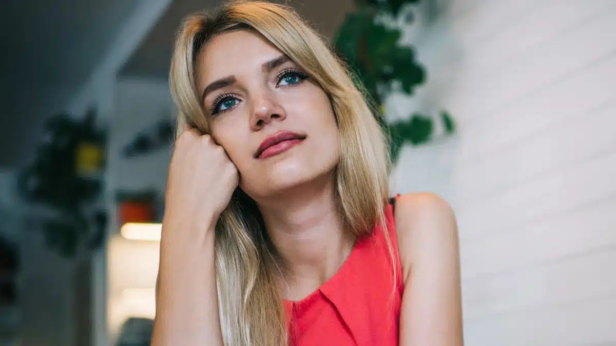 woman thinking alone red dress