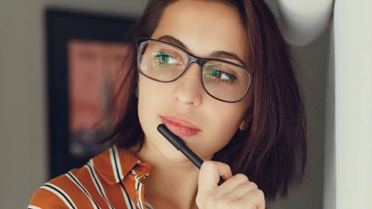 woman thinking pen in hand