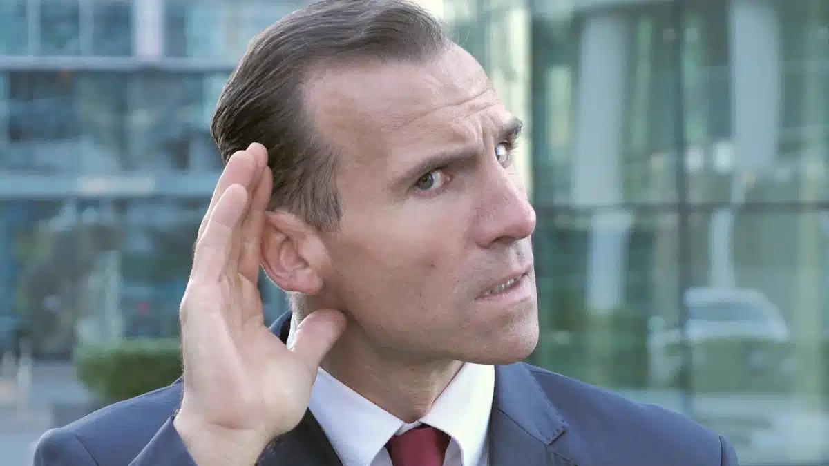 business man listening to secret
