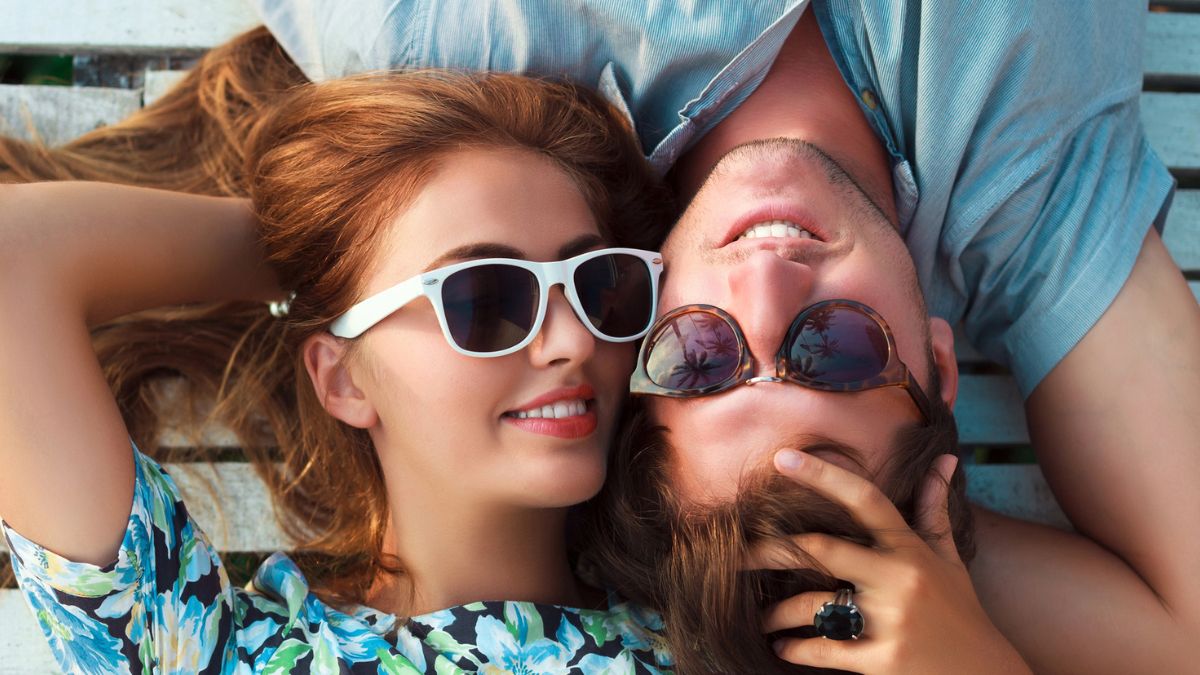 couple laying down with sun glasses