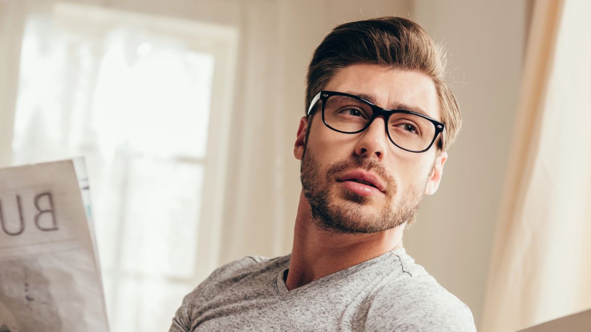 man glasses reading newspaper