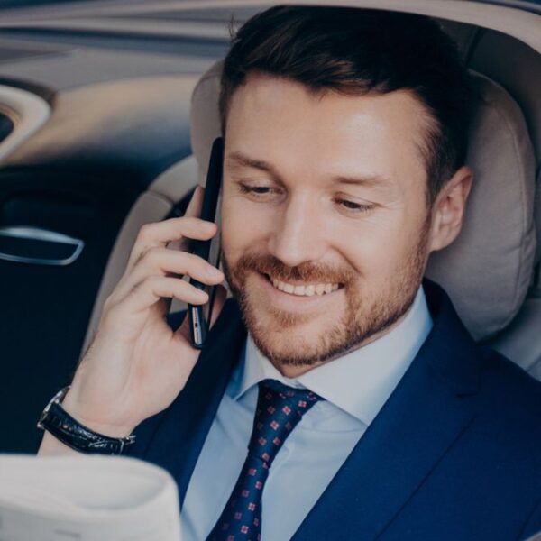 man sitting in the back of a car