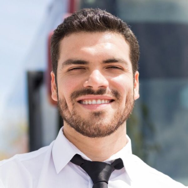 man standing in front of a bus