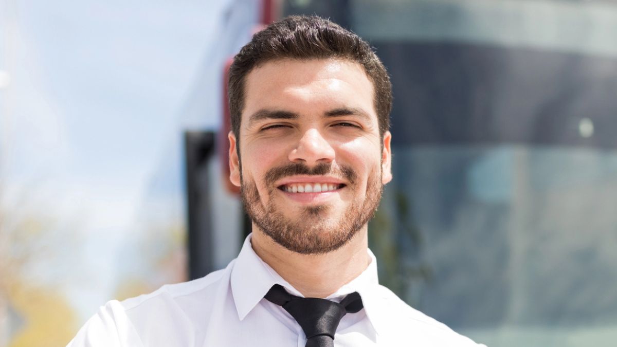 man standing in front of a bus