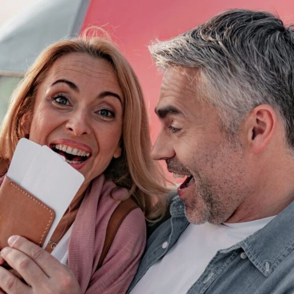 mature couple holding passport