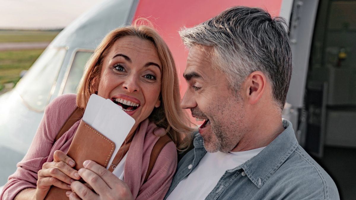 mature couple holding passport