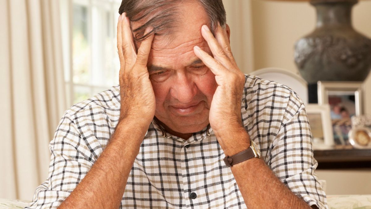 senior man worried at home