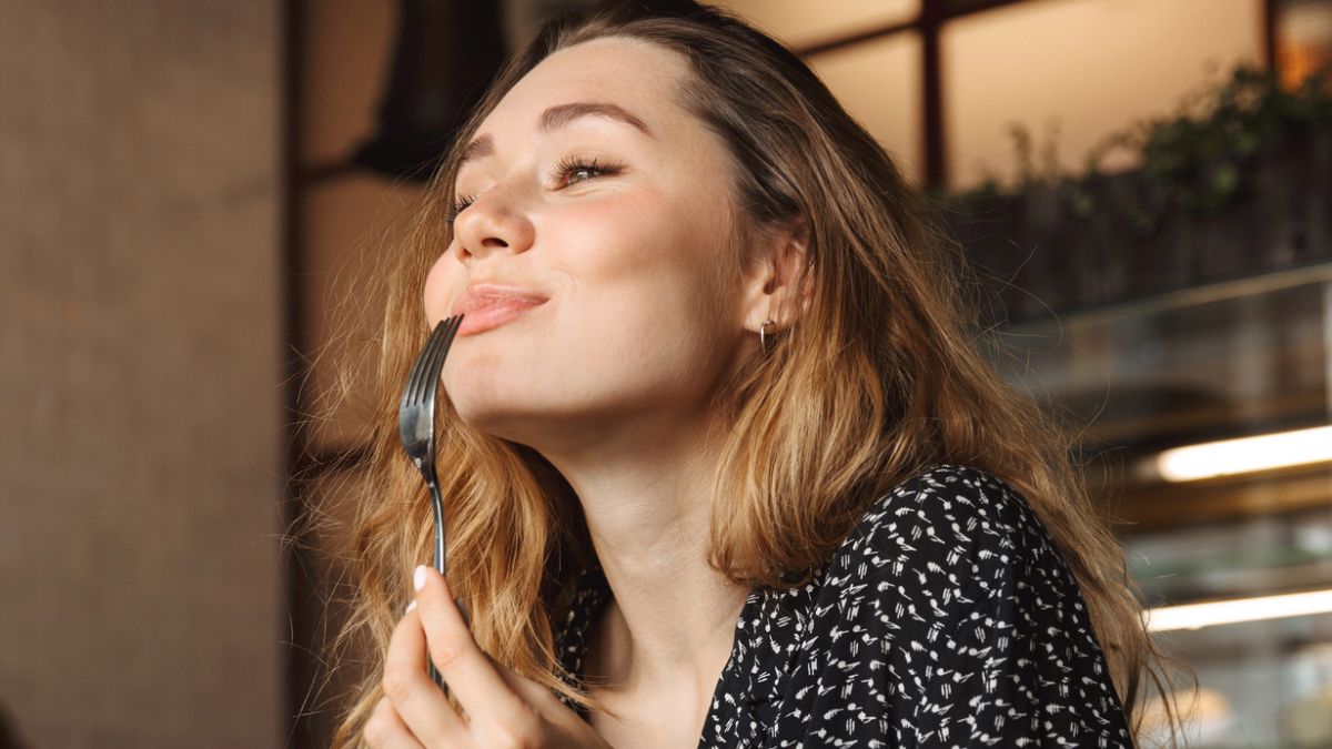 woman biting on a fork